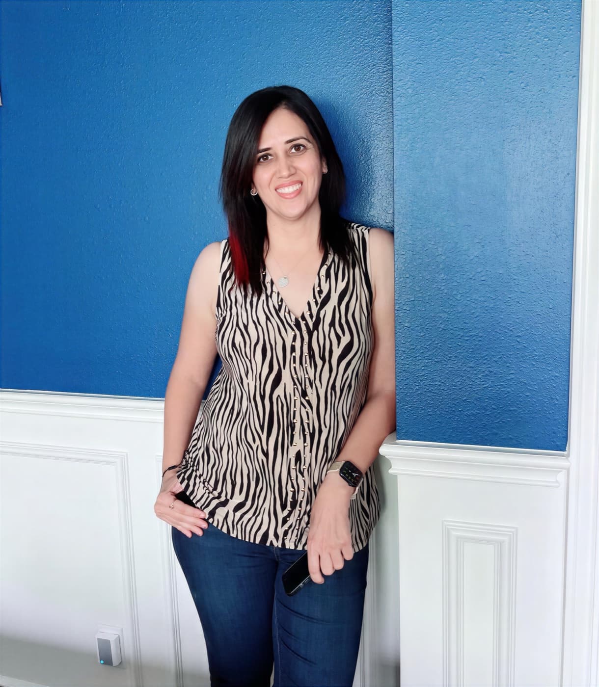 Sweta Dassani, photographed against a blue wall